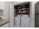 Conveniently located laundry room with washer, dryer, and storage shelving at 215 Summit North Ne Dr, Atlanta, GA 30324