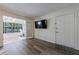 Bright living room featuring hardwood floors, white walls, and a sunroom at 215 Summit North Ne Dr, Atlanta, GA 30324