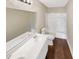 Bathroom featuring hardwood floors, and shower over tub at 690 Horsley Mill Rd, Carrollton, GA 30116