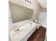 Well-lit bathroom featuring double sinks, white cabinets, and shower-tub combo at 690 Horsley Mill Rd, Carrollton, GA 30116
