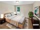 Bright bedroom with a neutral color scheme, a large bed, and simple decor creating a calming atmosphere at 690 Horsley Mill Rd, Carrollton, GA 30116