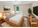 Staged bedroom featuring neutral colors, carpet floors, and a window with natural light at 690 Horsley Mill Rd, Carrollton, GA 30116