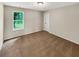 A bright bedroom with a window letting in natural light and neutral colored walls at 690 Horsley Mill Rd, Carrollton, GA 30116