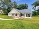 Charming single-story home with a metal roof, black shutters and a well-maintained lawn at 690 Horsley Mill Rd, Carrollton, GA 30116