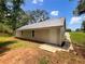 Rear exterior of a single-story home featuring a door and a small, well-maintained lawn at 690 Horsley Mill Rd, Carrollton, GA 30116
