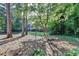 View of the backyard featuring mature trees and a well-manicured lawn at 882 Cedar Canyon Se Sq, Marietta, GA 30067