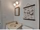 Updated bathroom with marble countertop, butterfly wall art, and modern lighting at 882 Cedar Canyon Se Sq, Marietta, GA 30067