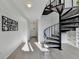 Bright entryway featuring a spiral staircase, light wood floors, and stylish wall art at 882 Cedar Canyon Se Sq, Marietta, GA 30067