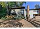 Exterior of a two-story home with a brick chimney and lush greenery in the background at 882 Cedar Canyon Se Sq, Marietta, GA 30067