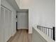 Upstairs hallway with closet doors and light hardwood floors throughout at 882 Cedar Canyon Se Sq, Marietta, GA 30067
