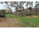 Serene view of the backyard with mature trees that back up to the Chattahoochee River at 1026 Riverbend Club Se Dr, Atlanta, GA 30339