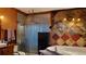 An eclectic bathroom featuring a shower, jacuzzi tub and brown and gray tile at 1026 Riverbend Club Se Dr, Atlanta, GA 30339