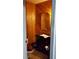 Rustic half bath with wood paneling, featuring a unique vanity and toilet setup in a compact space at 1026 Riverbend Club Se Dr, Atlanta, GA 30339