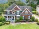 Aerial view of a beautiful brick home with a perfectly manicured lawn and mature landscaping at 1409 Echo Mill Dr, Powder Springs, GA 30127