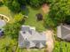 Aerial view of home with lush backyard featuring a trampoline, playset and mature trees at 1409 Echo Mill Dr, Powder Springs, GA 30127