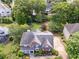Aerial view showcasing a beautiful brick home with mature trees, landscaped yard and neighborhood at 1409 Echo Mill Dr, Powder Springs, GA 30127