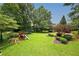 Lush backyard featuring a playground and landscaped garden beds at 1409 Echo Mill Dr, Powder Springs, GA 30127