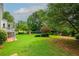 Expansive backyard with lush lawn, mature trees, and play set, perfect for outdoor activities at 1409 Echo Mill Dr, Powder Springs, GA 30127