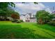 Expansive backyard featuring a well-manicured lawn, multi-level deck, and play structure at 1409 Echo Mill Dr, Powder Springs, GA 30127