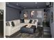 Finished basement with large sectional sofa, area rug, and movie posters create a cozy entertainment space at 1409 Echo Mill Dr, Powder Springs, GA 30127