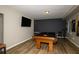 Basement entertainment area with pool table, mounted television, and wood-look flooring at 1409 Echo Mill Dr, Powder Springs, GA 30127
