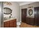 Bathroom featuring wood-look tile flooring, granite vanity, toilet, and linen cabinets at 1409 Echo Mill Dr, Powder Springs, GA 30127