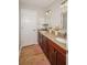 Bathroom featuring a double vanity with granite countertops and wood-look tile at 1409 Echo Mill Dr, Powder Springs, GA 30127
