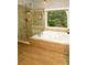Modern bathroom featuring a glass enclosed shower and a garden tub at 1409 Echo Mill Dr, Powder Springs, GA 30127