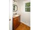 Bathroom features hardwood floors, granite countertop, wooden vanity and window at 1409 Echo Mill Dr, Powder Springs, GA 30127