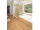 Elegant bathroom featuring a glass enclosed shower, a bathtub, and wood flooring at 1409 Echo Mill Dr, Powder Springs, GA 30127