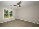 This bedroom has neutral walls, carpet, and a window overlooking the front yard at 1409 Echo Mill Dr, Powder Springs, GA 30127