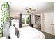 Stylish bedroom with a ceiling fan, white dresser and closet workstation at 1409 Echo Mill Dr, Powder Springs, GA 30127
