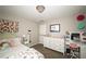 Bedroom featuring a white dresser, vanity and decorative floral wall art at 1409 Echo Mill Dr, Powder Springs, GA 30127