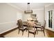 Traditional dining room with crown molding, hardwood floors, and modern light fixture at 1409 Echo Mill Dr, Powder Springs, GA 30127