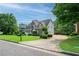 Charming home featuring lush landscaping, a long driveway, and mature trees at 1409 Echo Mill Dr, Powder Springs, GA 30127