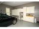 Spacious garage with storage cabinets, shelving and epoxy flooring at 1409 Echo Mill Dr, Powder Springs, GA 30127