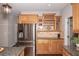 This functional kitchen features wood cabinets, stainless steel appliances, and granite countertops at 1409 Echo Mill Dr, Powder Springs, GA 30127
