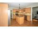Bright kitchen boasts wood cabinets, stainless appliances and a functional island with granite countertops at 1409 Echo Mill Dr, Powder Springs, GA 30127