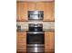 A close-up view of stainless steel appliances and beautiful granite countertops in this bright kitchen at 1409 Echo Mill Dr, Powder Springs, GA 30127