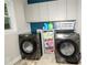 Modern laundry room with a washer, dryer, storage, and natural light at 1409 Echo Mill Dr, Powder Springs, GA 30127