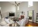 An open-concept living room with high ceilings, fireplace, and access to an outdoor deck at 1409 Echo Mill Dr, Powder Springs, GA 30127