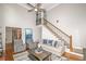 Bright living room features staircase, hardwood floors, ceiling fan, and modern furniture at 1409 Echo Mill Dr, Powder Springs, GA 30127