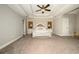 Spacious primary bedroom with tray ceiling and sitting area at 1409 Echo Mill Dr, Powder Springs, GA 30127
