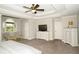 Primary bedroom showcasing a ceiling fan, sitting area, and television at 1409 Echo Mill Dr, Powder Springs, GA 30127