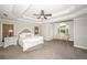 Spacious primary bedroom with a tray ceiling and large windows at 1409 Echo Mill Dr, Powder Springs, GA 30127