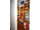 Well-organized walk-in pantry with custom wood shelving, storage and hardwood floors at 1409 Echo Mill Dr, Powder Springs, GA 30127