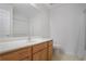 Bathroom featuring a large mirror, vanity with cabinets, and shower with curtain at 2594 Laurel Nw Cir, Atlanta, GA 30311