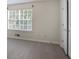 Cozy bedroom featuring a window and neutral-colored walls and flooring at 2594 Laurel Nw Cir, Atlanta, GA 30311