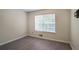 Bedroom with a large window offering natural light and neutral flooring at 2594 Laurel Nw Cir, Atlanta, GA 30311