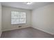 Comfortable bedroom with large window and neutral-colored flooring at 2594 Laurel Nw Cir, Atlanta, GA 30311